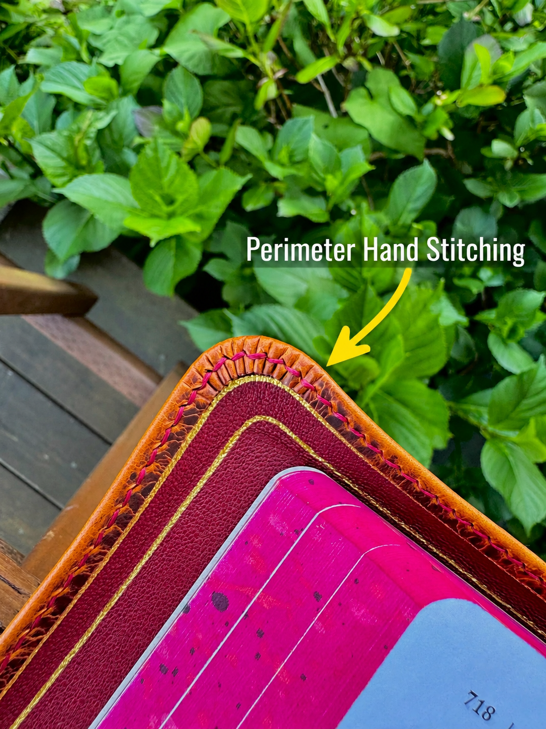 Hand stitching on burgundy leather Bible with blue liner